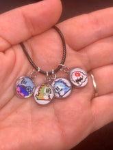 Load image into Gallery viewer, Nintendo Inspired Bubble Bobble 8-bit Retro Charm Necklace On Waxed Black Adjustable Cord Blue, Green, and bad guy Character Charms